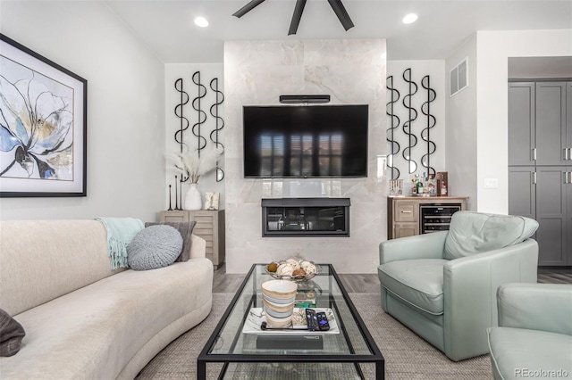 10524 Eby Cir, Lone Tree, CO 80124 - living room featuring beverage cooler, recessed lighting, a ceiling fan, a fireplace, and bar area