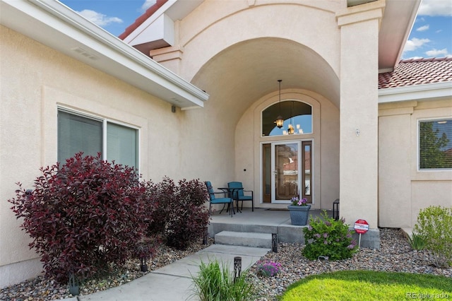 335 Mountain Brush, Colorado Springs, CO 80921 - property entrance with a porch, stucco siding, and a tiled roof