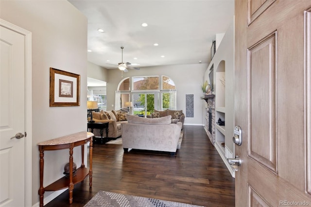 335 Mountain Brush, Colorado Springs, CO 80921 - living area featuring dark wood finished floors, a ceiling fan, recessed lighting, a stone fireplace, and baseboards