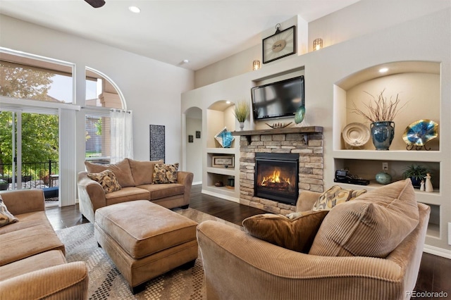 335 Mountain Brush, Colorado Springs, CO 80921 - living room with healthy amount of natural light, a stone fireplace, wood finished floors, a high ceiling, and recessed lighting