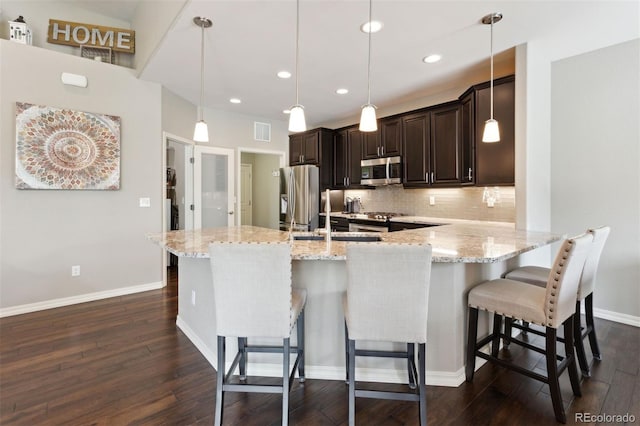 335 Mountain Brush, Colorado Springs, CO 80921 - kitchen featuring stainless steel appliances, dark wood-style flooring, backsplash, dark brown cabinetry, and recessed lighting