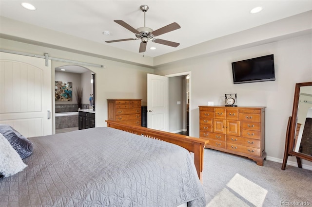 335 Mountain Brush, Colorado Springs, CO 80921 - bedroom featuring light colored carpet, recessed lighting, connected bathroom, ceiling fan, and arched walkways