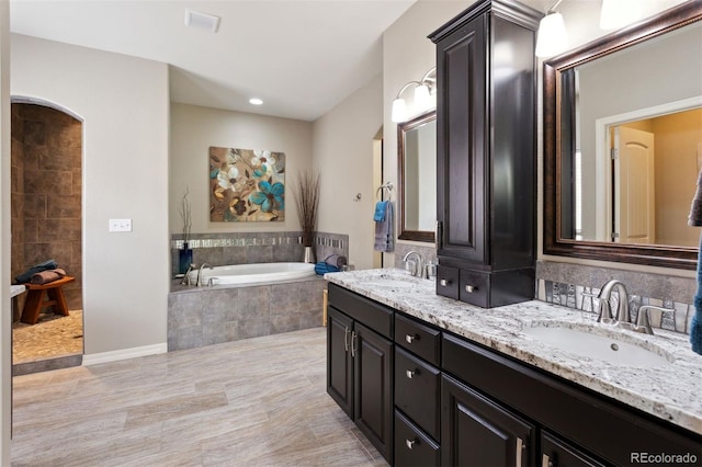 335 Mountain Brush, Colorado Springs, CO 80921 - full bathroom featuring a garden tub, double vanity, baseboards, and recessed lighting