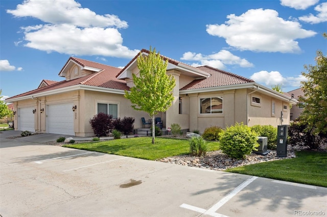 335 Mountain Brush, Colorado Springs, CO 80921 - view of front of house with a tiled roof, stucco siding, an attached garage, and a front yard