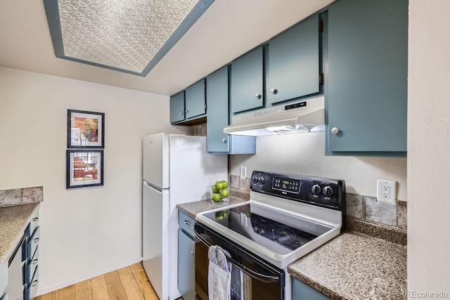 kitchen featuring white refrigerator, blue cabinets, light hardwood / wood-style flooring, and range with electric stovetop