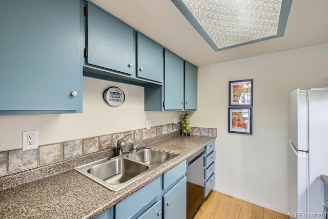 kitchen featuring blue cabinetry, sink, light wood-type flooring, white refrigerator, and dishwasher