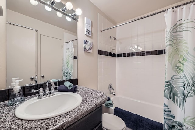 full bathroom featuring vanity, shower / tub combo, and toilet