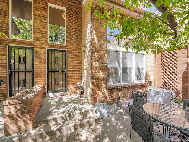 1011 N Pennsylvania St Unit H, Denver, CO 80203 - doorway to property with brick siding and outdoor dining space