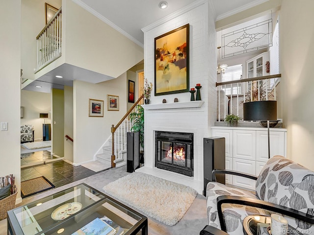 1011 N Pennsylvania St Unit H, Denver, CO 80203 - living area with ornamental molding, a large fireplace, stairs, baseboards, and a towering ceiling