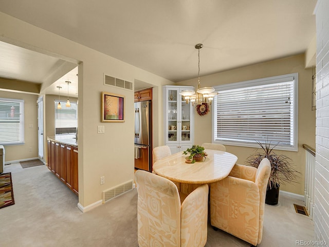 1011 N Pennsylvania St Unit H, Denver, CO 80203 - dining space with a chandelier, light colored carpet, and baseboards