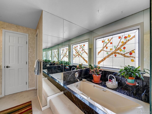1011 N Pennsylvania St Unit H, Denver, CO 80203 - bathroom featuring a bath and baseboards