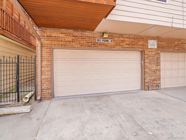 1011 N Pennsylvania St Unit H, Denver, CO 80203 - garage featuring fence and concrete driveway