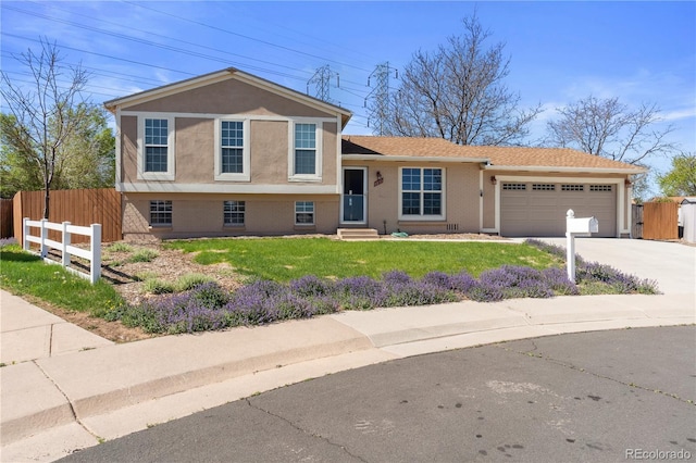 1853 S Zeno Way, Aurora, CO 80017 - split level home featuring a garage, concrete driveway, and stucco siding