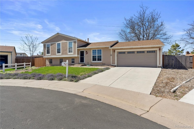 1853 S Zeno Way, Aurora, CO 80017 - split level home with an attached garage, stucco siding, concrete driveway, and roof with shingles