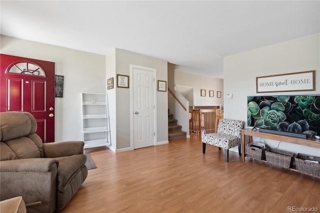 1853 S Zeno Way, Aurora, CO 80017 - living room featuring light wood-type flooring, stairway, and baseboards