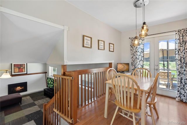 1853 S Zeno Way, Aurora, CO 80017 - dining space featuring wood finished floors, a warm lit fireplace, and french doors