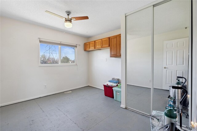 1853 S Zeno Way, Aurora, CO 80017 - bedroom with baseboards, a textured ceiling, a ceiling fan, and a closet