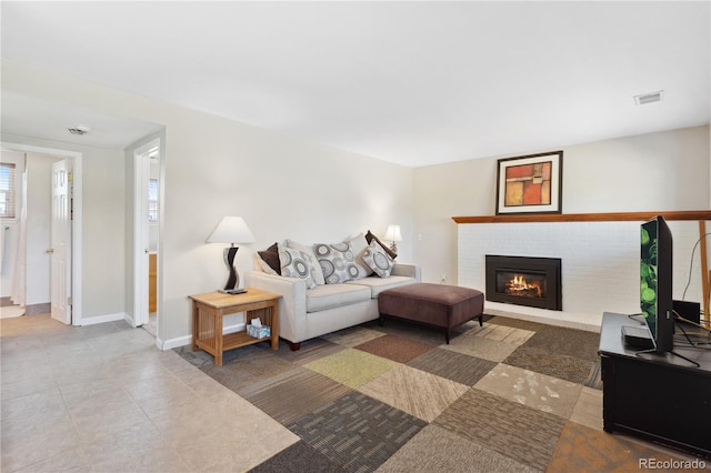 1853 S Zeno Way, Aurora, CO 80017 - tiled living room featuring a fireplace and baseboards