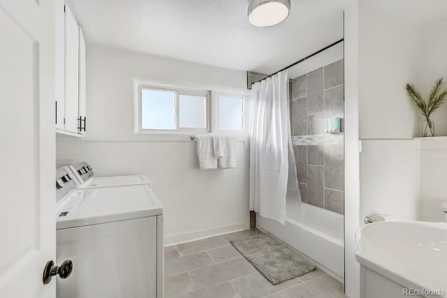 full bath featuring vanity, tile patterned floors, shower / bath combo with shower curtain, and washing machine and clothes dryer