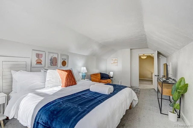 carpeted bedroom featuring vaulted ceiling