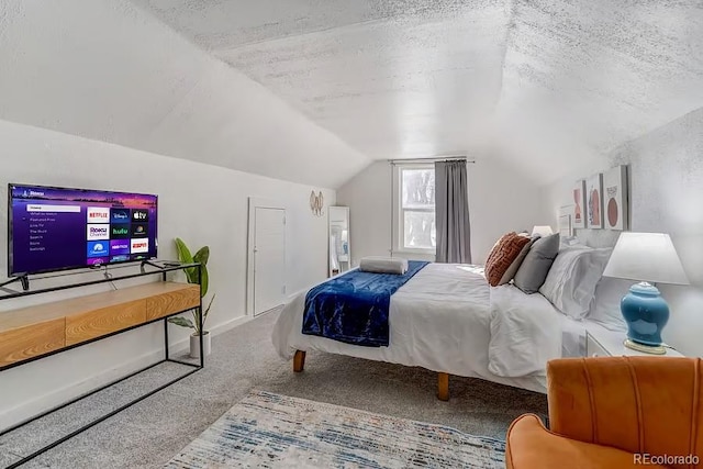 bedroom with carpet floors, a textured ceiling, and lofted ceiling