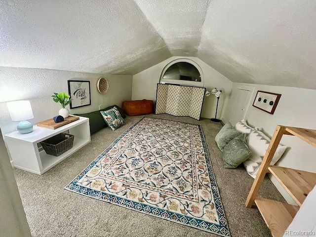 bedroom featuring carpet floors, a textured ceiling, and lofted ceiling