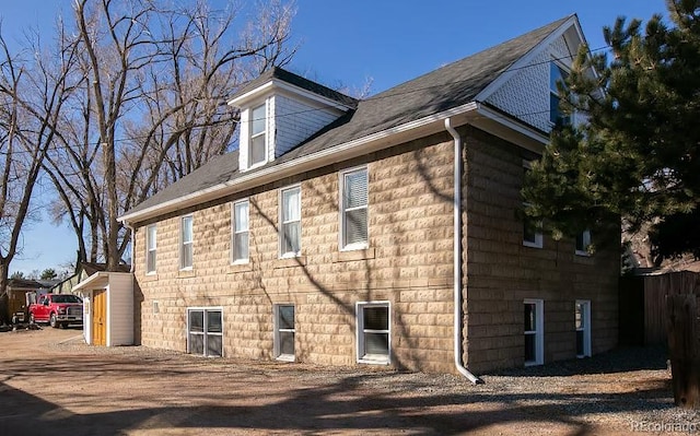view of side of home with fence