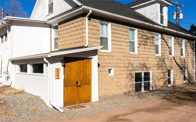 view of property exterior featuring a shingled roof