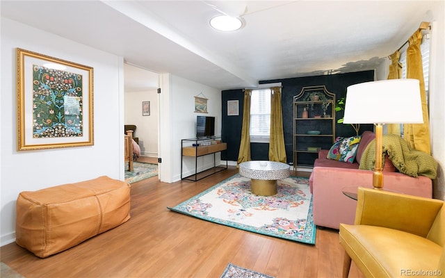 living room featuring baseboards and wood finished floors