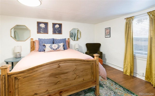 bedroom featuring baseboards and wood finished floors