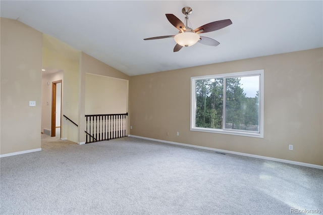 unfurnished room with ceiling fan, visible vents, baseboards, lofted ceiling, and carpet flooring