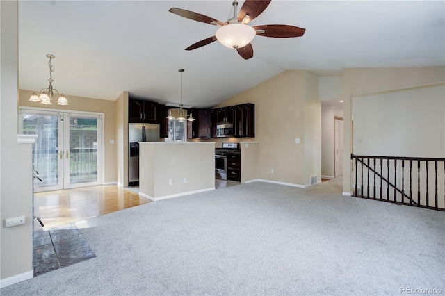 unfurnished living room with light carpet, french doors, ceiling fan with notable chandelier, baseboards, and lofted ceiling