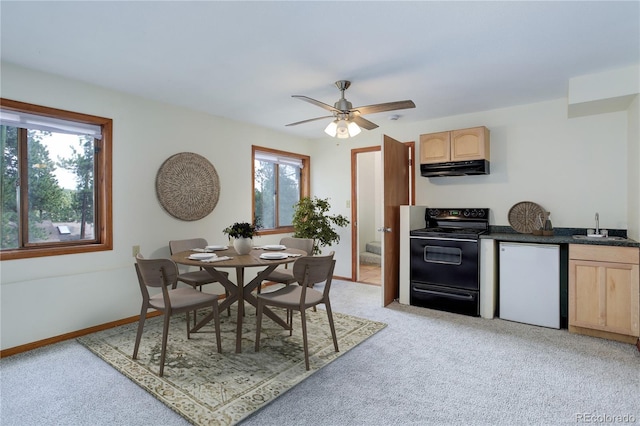 kitchen with dishwasher, a sink, light brown cabinets, light carpet, and black range with electric cooktop