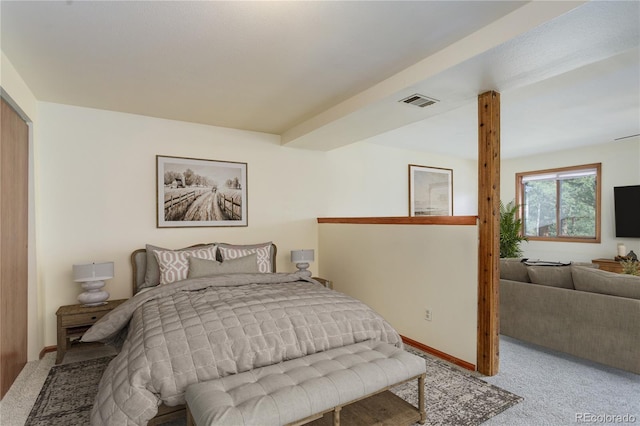 carpeted bedroom featuring baseboards and visible vents