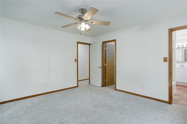 unfurnished bedroom featuring baseboards, ceiling fan, light carpet, and connected bathroom