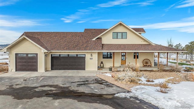 view of front facade featuring a garage and covered porch