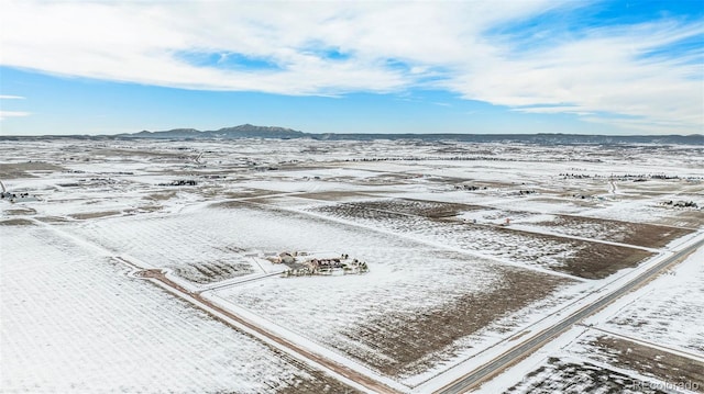 snowy aerial view featuring a mountain view