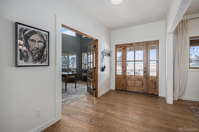 entryway featuring hardwood / wood-style flooring and french doors