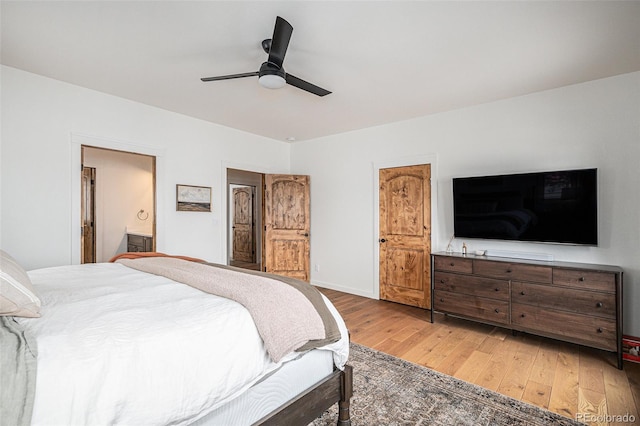 bedroom featuring ceiling fan, connected bathroom, and hardwood / wood-style floors