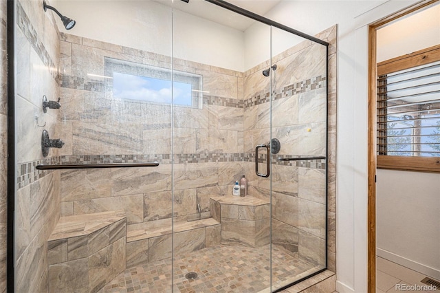 bathroom featuring a shower with door