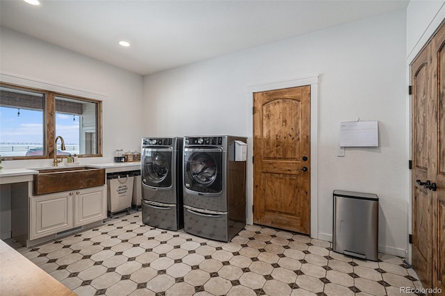 washroom with separate washer and dryer, sink, and cabinets