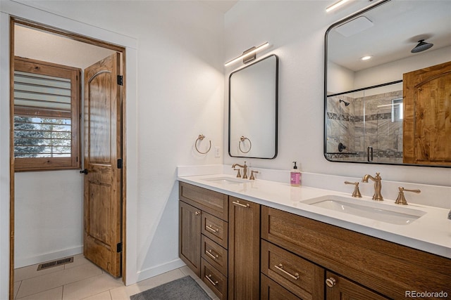 bathroom featuring tile patterned flooring, vanity, and walk in shower