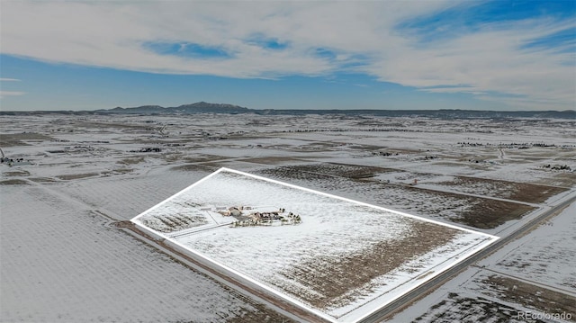 snowy aerial view with a mountain view