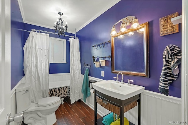 full bathroom with an inviting chandelier, toilet, vanity, shower / tub combo, and ornamental molding