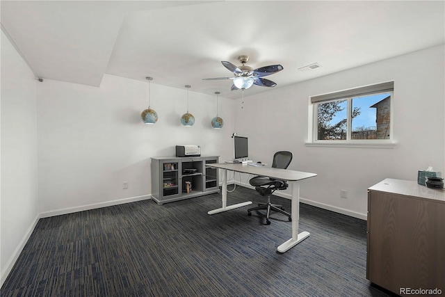 office area with ceiling fan and dark colored carpet