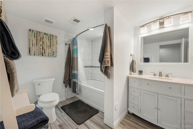 full bathroom with vanity, shower / tub combo, and toilet