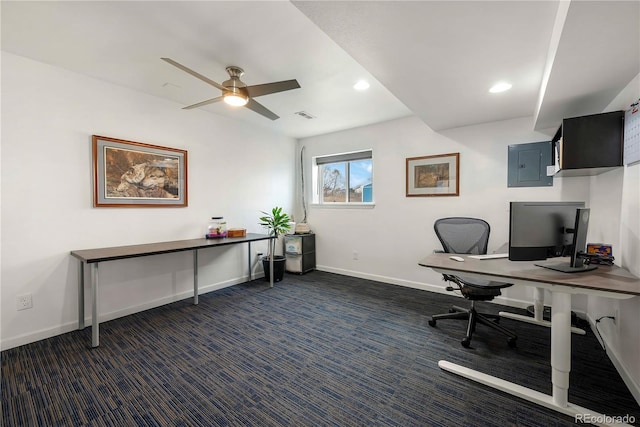 office space with dark colored carpet, electric panel, and ceiling fan