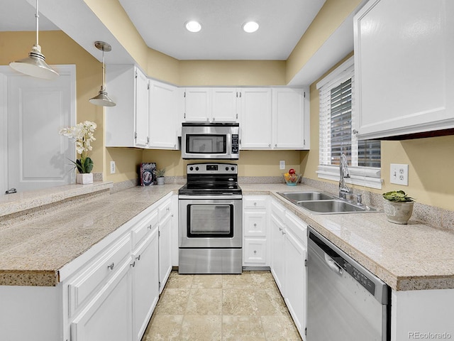 kitchen featuring sink, hanging light fixtures, white cabinets, and appliances with stainless steel finishes