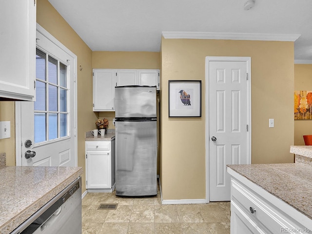 kitchen with white cabinetry, ornamental molding, and stainless steel appliances