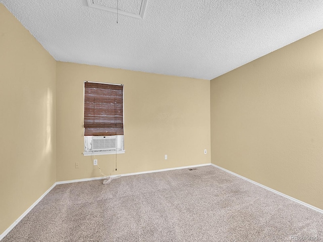 carpeted spare room with a textured ceiling